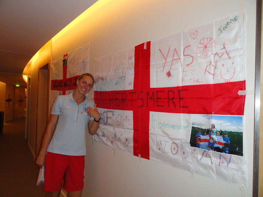 England captain Faye White stands proudly beside a flag sent over to Germany from Hertsmere.